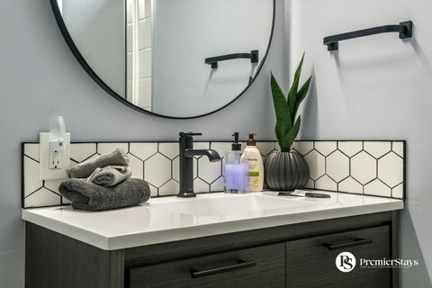 Sleek bathroom vanity with contemporary black faucet and elegant hexagonal tile