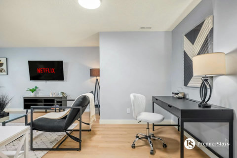 Stylish living space combining entertainment and workspace with contemporary furnishings