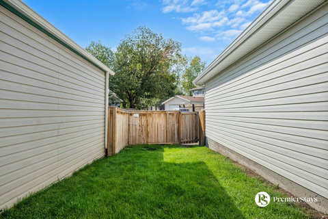 Private fenced backyard with mature trees and secure gate access