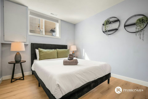 Stylish guest bedroom with contemporary black bed and soft green pillows