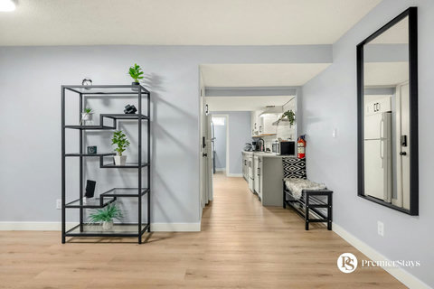 Bright, open hallway connecting living spaces with stylish industrial shelving