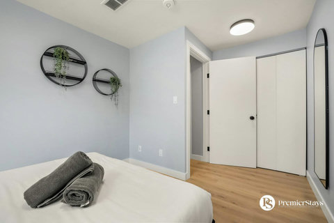 Serene guest bedroom with plenty of natural light and built-in storage solutions.