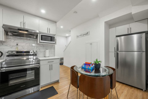 Sleek modern kitchen with stainless steel appliances and intimate dining nook