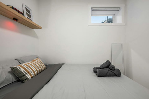 Bright guest bedroom with natural light and modern minimalist design