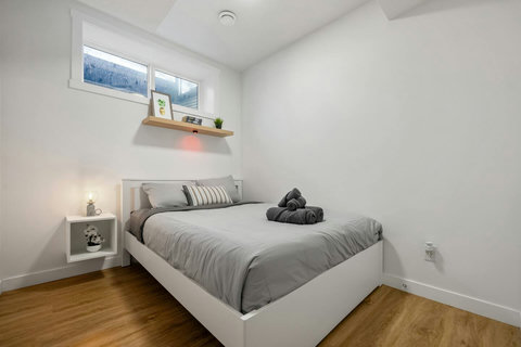 Serene guest bedroom with abundant natural light and modern furnishings.