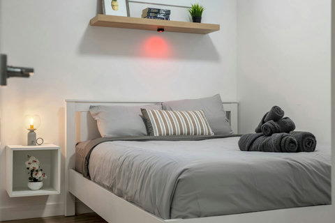 Stylish guest bedroom with soft lighting and quality bedding throughout.