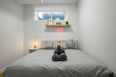 Intimate guest bedroom with natural light and thoughtful styling