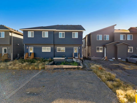 Contemporary duplex with inviting front entrance and private driveway