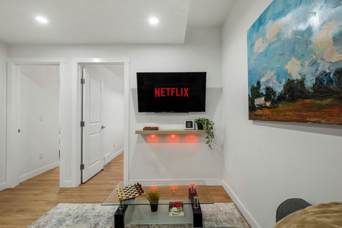 Stylish living room featuring a wall-mounted TV and ambient lighting