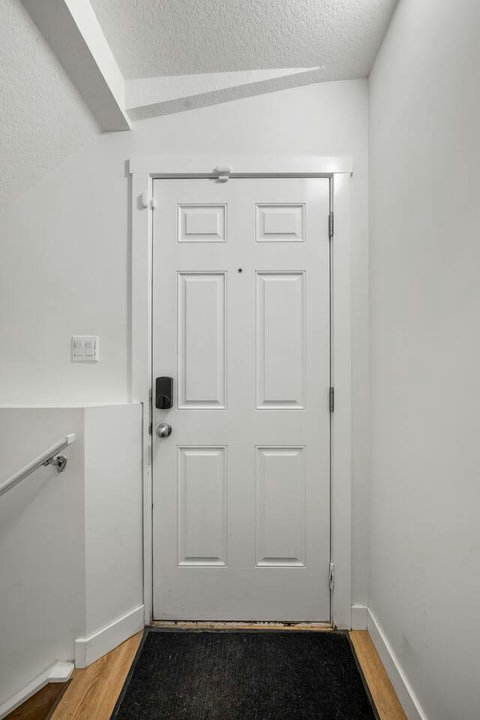 Welcoming entryway with classic six-panel door and modern fixtures