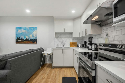 Sleek modern kitchen with stainless steel appliances and marble backsplash