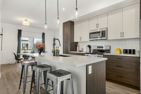 Stylish kitchen with stainless steel appliances and comfortable island seating