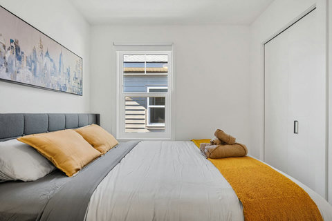 Bright modern bedroom with comfortable upholstered bed and cheerful décor