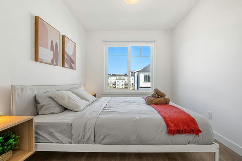 Cozy guest bedroom with natural light and urban views