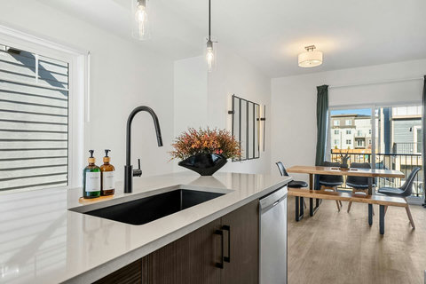 Sleek chef's kitchen overlooking the living and dining areas