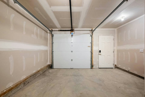 Spacious garage with overhead door and convenient interior entry