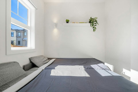 Serene guest bedroom filled with natural light and greenery