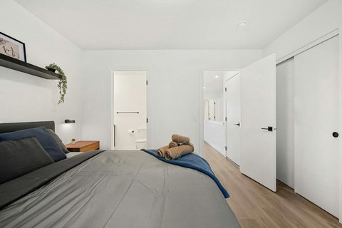 Serene guest bedroom featuring an ensuite bathroom and ample natural light