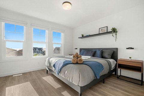 Airy primary bedroom with abundant natural light and scenic views