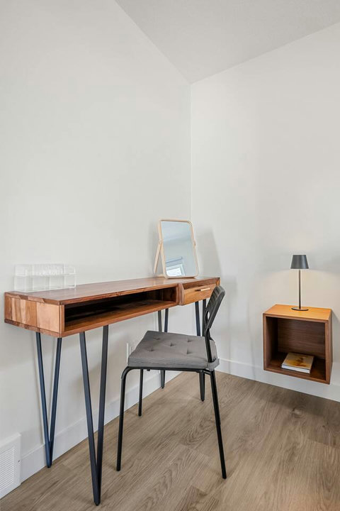 Dedicated workspace with natural wood desk and contemporary styling