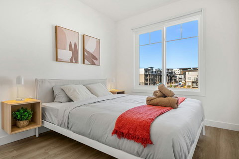 Airy guest bedroom with natural light and modern city views