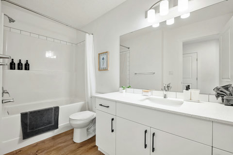 Spa-like master bathroom with elegant dual vanity and soaking tub