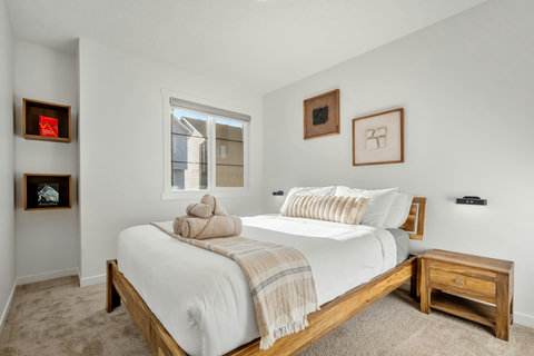 Comfortable guest bedroom with natural light and warm wood accents