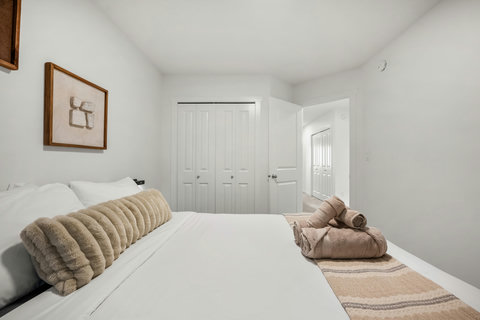 Serene guest bedroom with crisp white bedding and warm accents