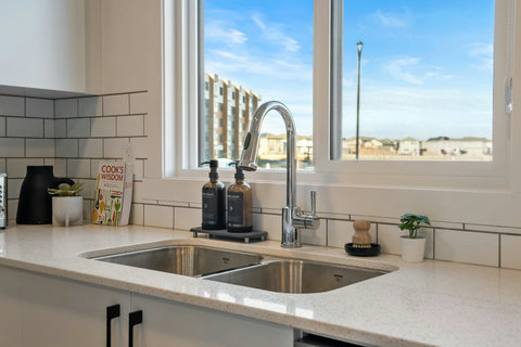Bright modern kitchen with double sink and stunning city skyline views