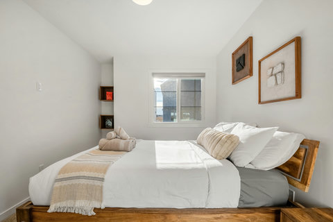 Serene guest bedroom flooded with natural light and modern comfort