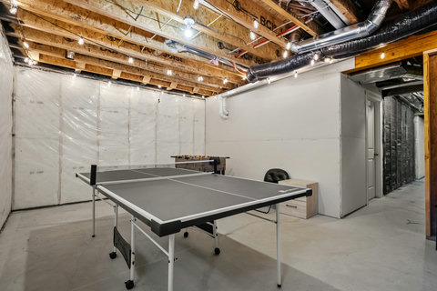 Recreational basement space with ping pong and foosball tables for entertainment