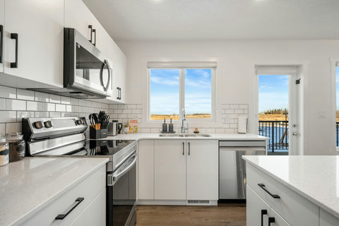 Bright modern kitchen with scenic landscape views and quality stainless steel appliances