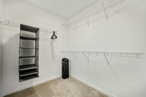 Generous walk-in closet with built-in shelving and ample storage solutions