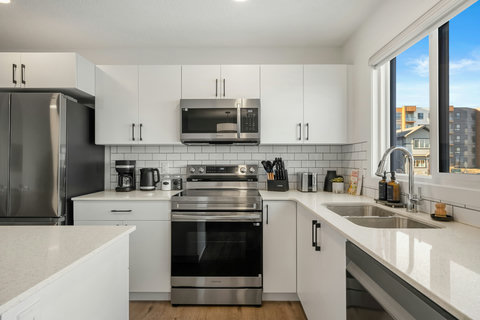 Sleek modern kitchen featuring stainless steel appliances and ample counter space