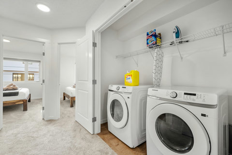 Fully equipped laundry room with modern washer and dryer appliances