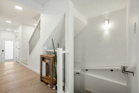 Welcome home to this bright, airy foyer with elegant staircase and natural lighting