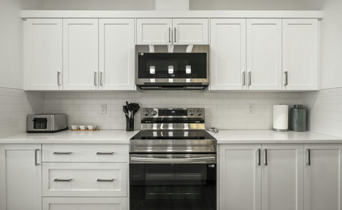 Bright, fully equipped kitchen with modern stainless steel appliances