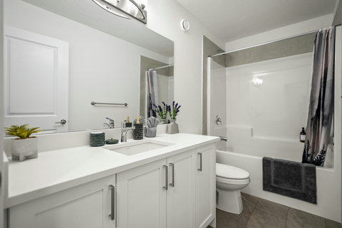 Spacious modern bathroom with dual vanity and soaking tub