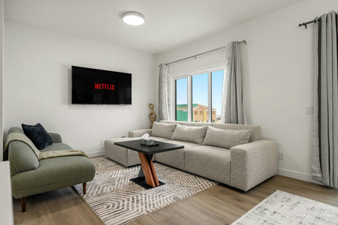 Comfortable living space with modern sectional and entertainment setup