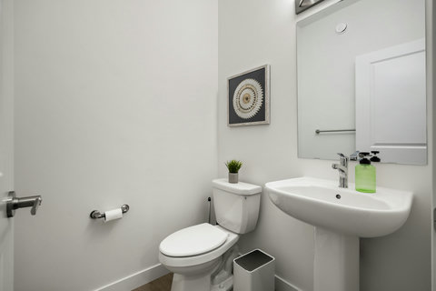 Stylish half bath with contemporary curved sink and mirror