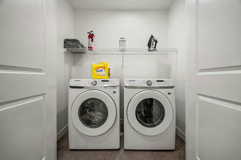 Convenient laundry room with modern Samsung washer and dryer units