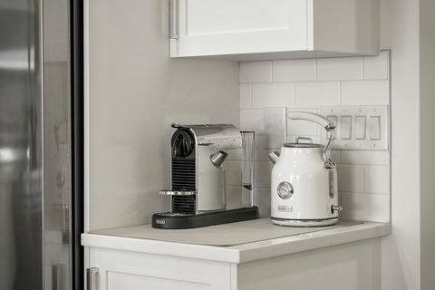 Stylish kitchen corner with premium coffee and tea appliances.
