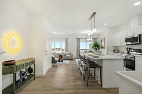 Bright open-concept kitchen flowing into comfortable living areas with views