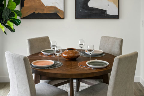 Intimate dining space with round wooden table and upholstered seating