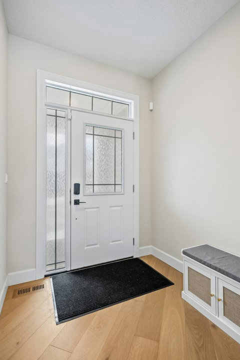 Welcoming entryway with natural light and convenient bench seating