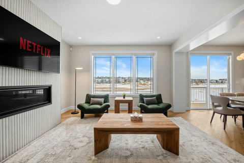 Gather around the fireplace and enjoy wide open views from the living room