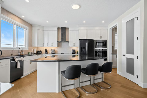 Cook in style in this sleek chef-ready kitchen with bar seating