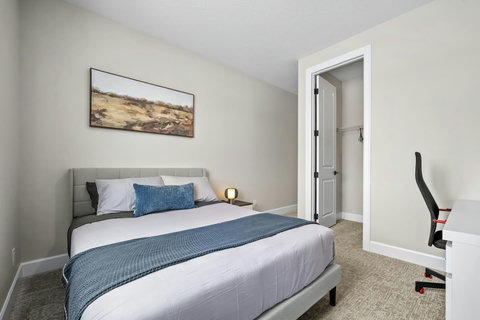 Drift off on crisp linens with plush pillows in this welcoming queen bed