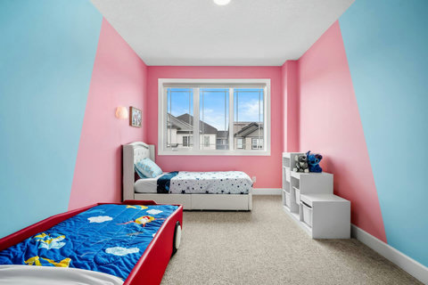 Two cosy beds in this playful kids room with cheerful two-tone painted walls