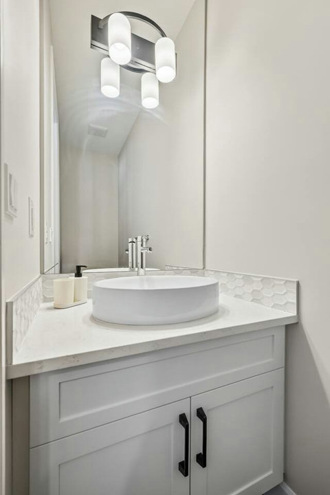 Chic powder room with vessel sink and stylish pendant lighting
